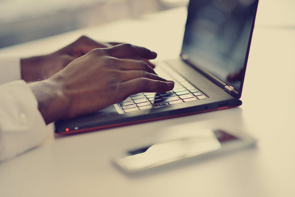 [Nigeria] 98% of workers will be exempted from PAYE in 2026 - Nigerian man working at laptop, 2026 PAYE exemptions Nigeria
