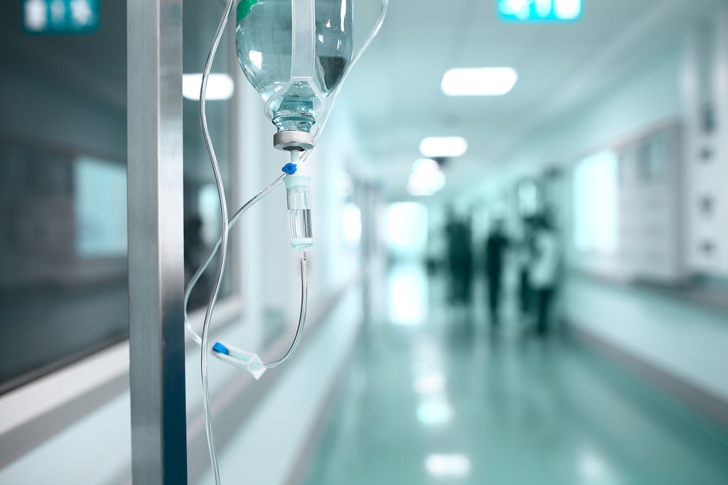 [South Africa] Gauteng Health Department freezes salaries over suspected payroll fraud - hospital corridor with drip in foreground, ghost workers on healrth department payroll