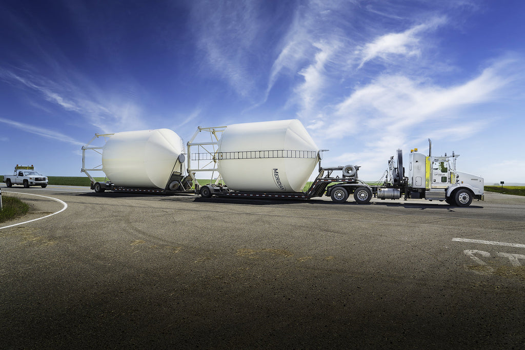 [Canada] Trucking industry campaign against costly payroll fraud schemes - trucker with grain silos Canada, payroll fraud schemes in Canadian trucking industry