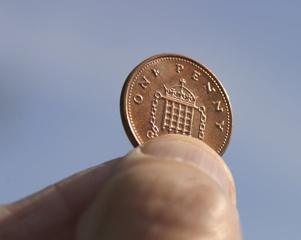 [UK] Businesses to be named and shamed for minimum wage breaches - holding a penny to the light, penny pinching, minimum wage breaches, name and shame