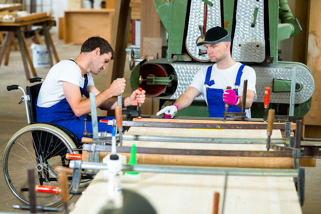 [Montenegro] Obligatory severance payments and longer annual leave for disabled workers - two carpenters at work station one in his wheelchair, Montenegro increased labour law rights for disabled workers
